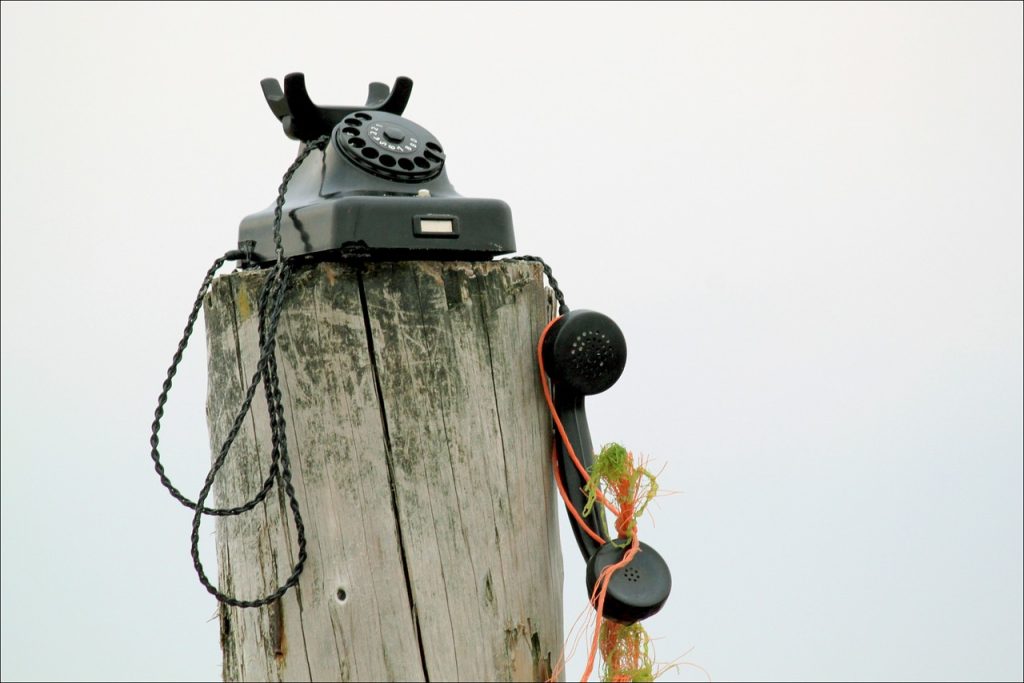 vintage phone on wooden post